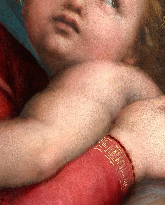 His arm clings to his mother's neck.
