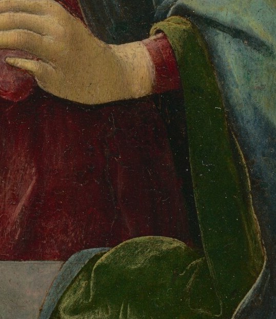 Core symbol of the painting: the split fruit with visible seeds signifies Christ's Passion, resurrection, and the unity of the Church , its redness mirrors his future blood.