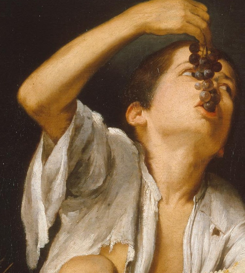The light makes his torn shirt shimmer like a saint's robe.