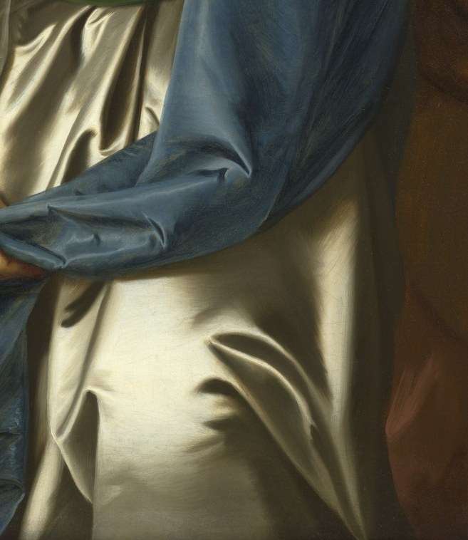 The rich blue fabric provides a striking contrast to her dress and adds a dynamic element to the composition.