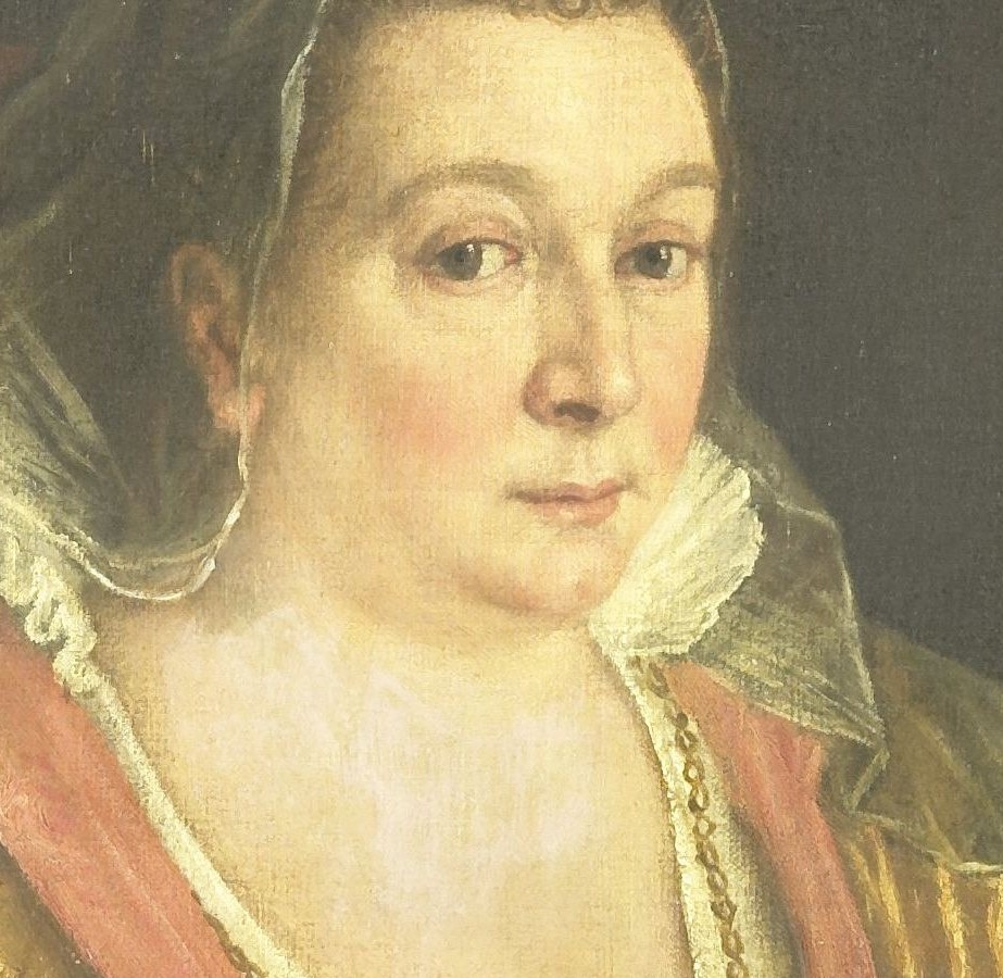 Her direct gaze and slightly parted lips suggest a moment of contemplation or quiet authority.