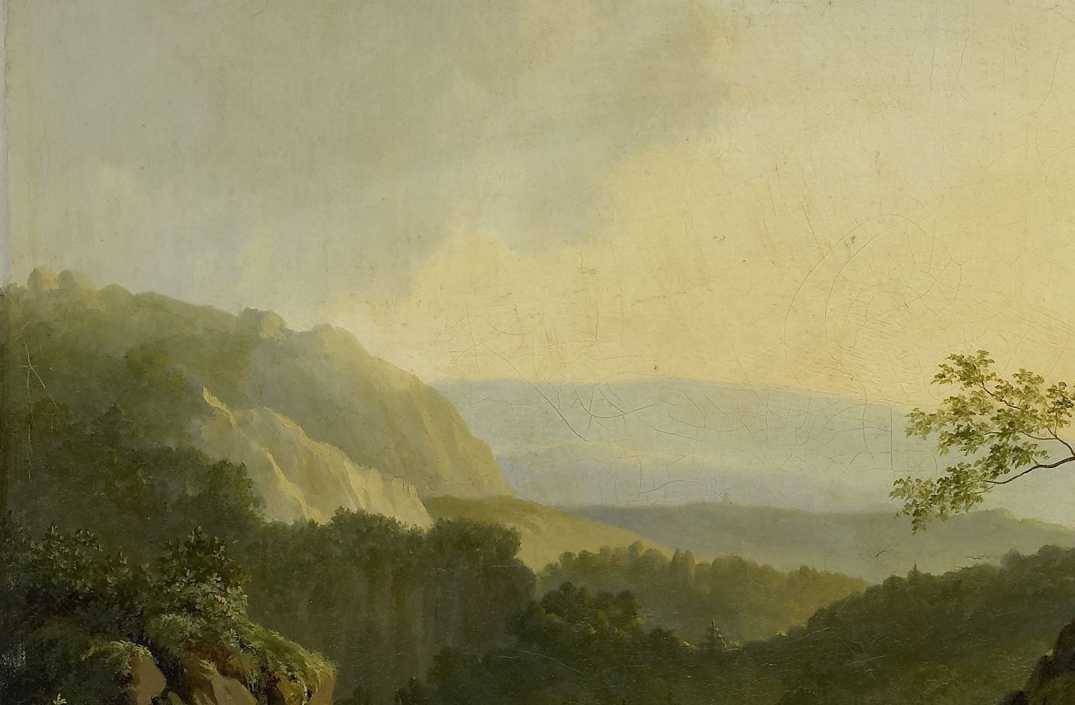 Beyond, mountains fade into a hazy, atmospheric distance.