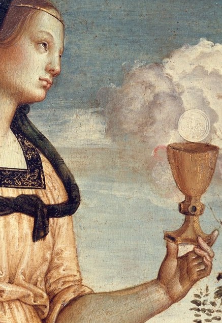The chalice she lifts catches the only strong light.