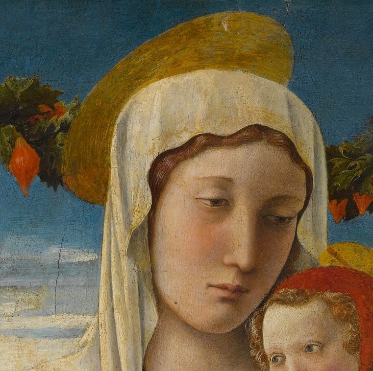 She looks down, heavy with sorrow.