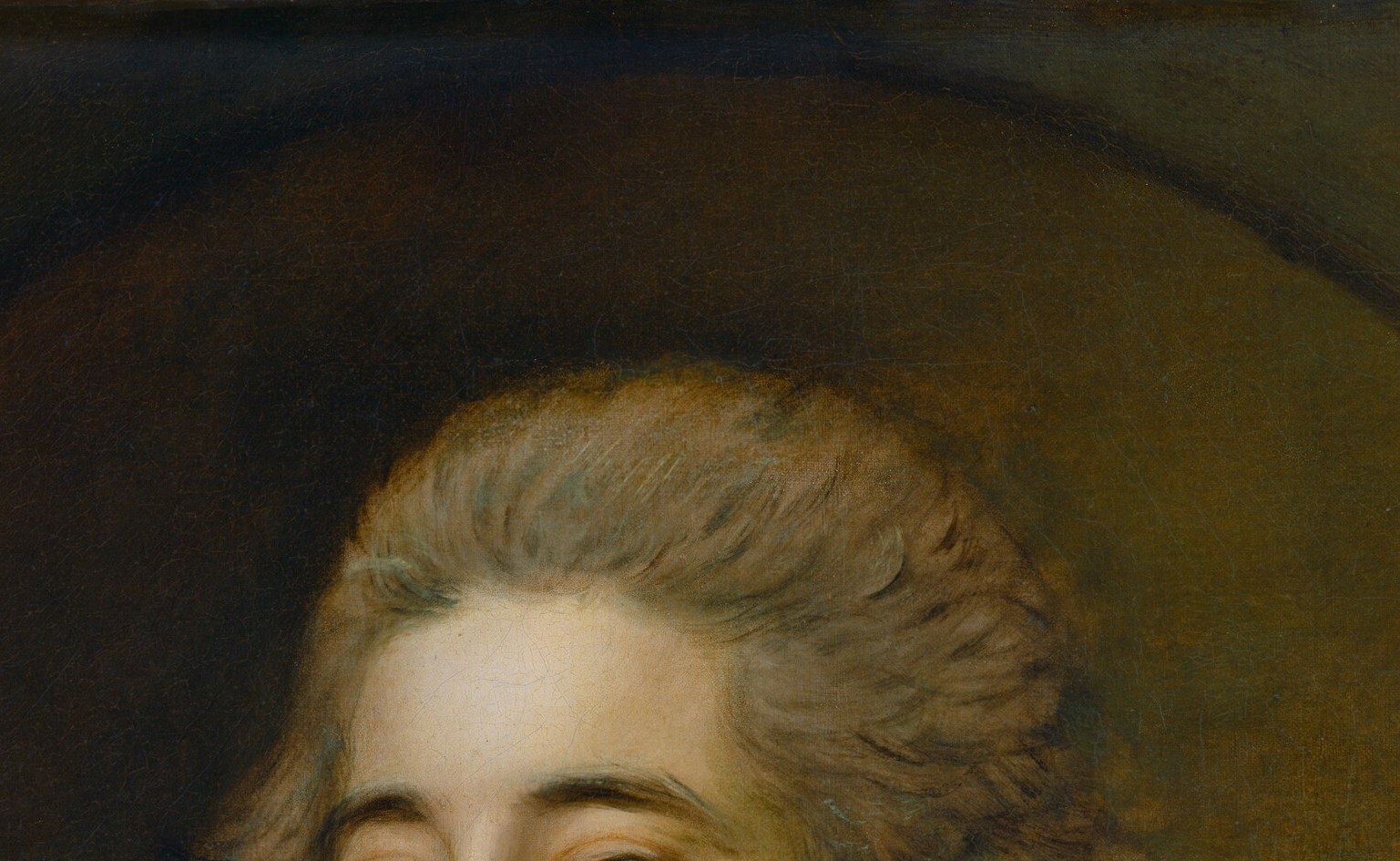 Worn loose and curled rather than in a formal powdered wig , a fashion signal of the 1780s reform toward naturalness, legible to period viewers as a statement of modernity.