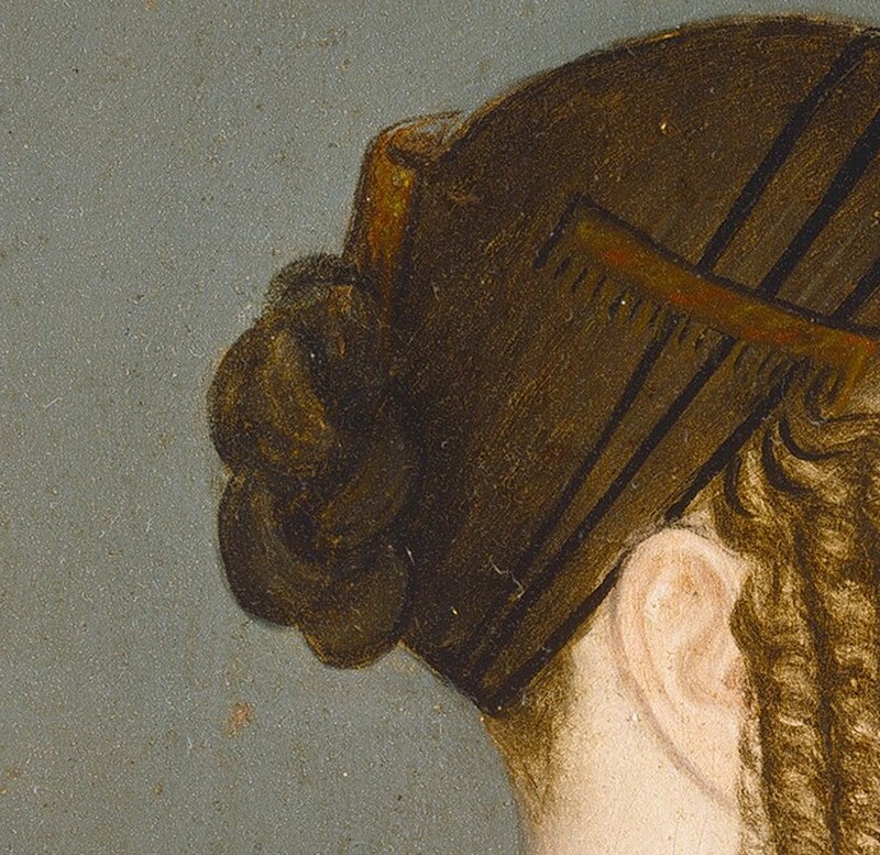 Her elegant hairstyle, pinned just so, reflects the fashion of 1835.