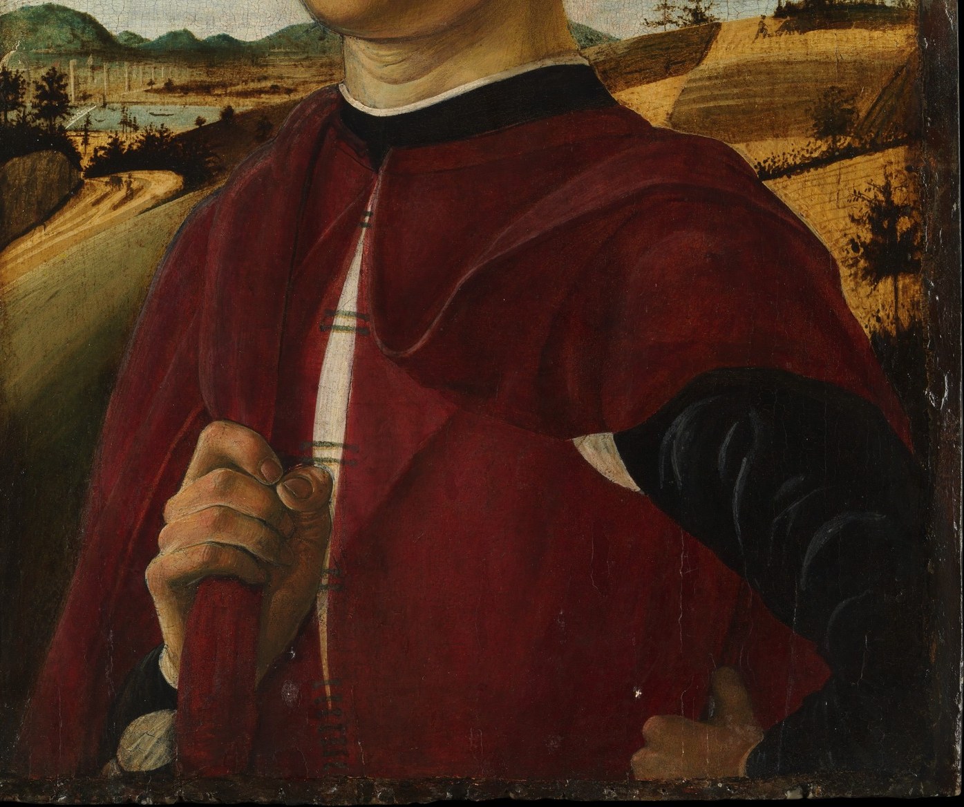 His red robe suggests a wealthy Florentine citizen.