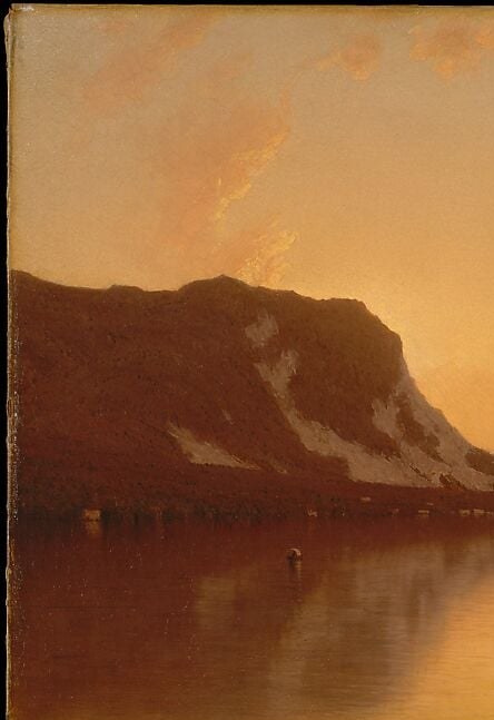 The dominant dark anchor of the composition; its sheer vertical mass against the glowing sky creates the tension that makes the openness of the lake feel immense