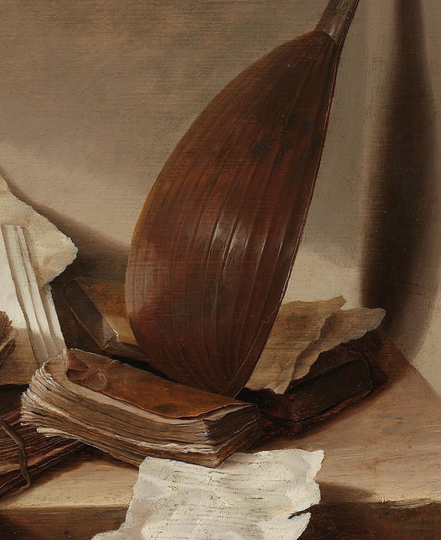 A lute rests against the books.