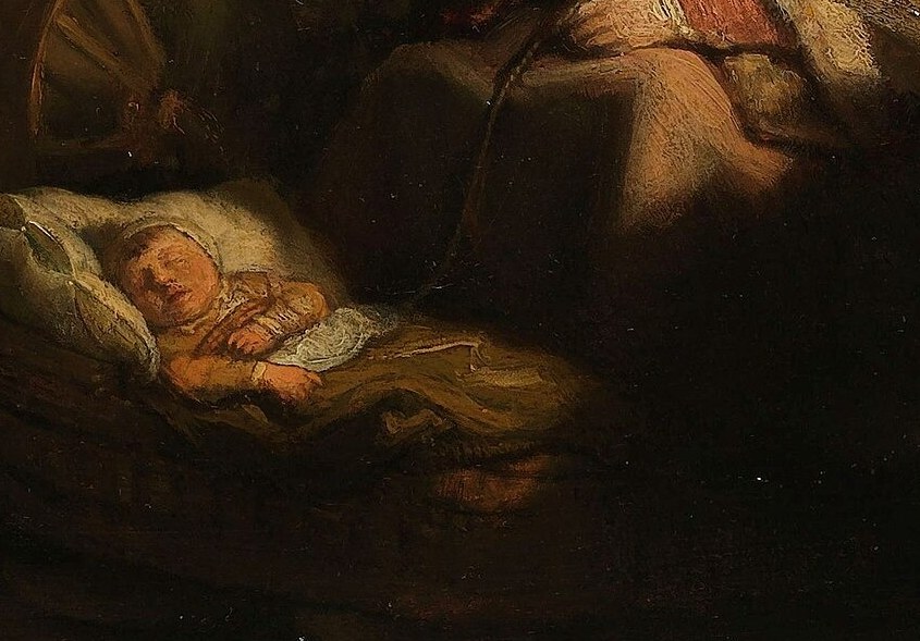 Light glows on the infant's face.