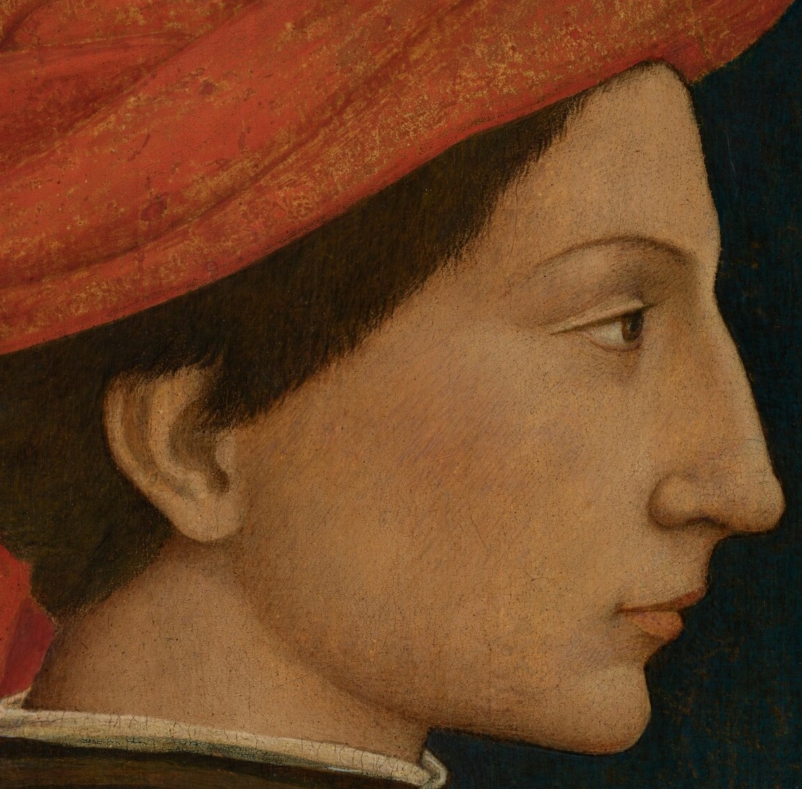 Look closely at the man’s profile, sharp against the dark background.