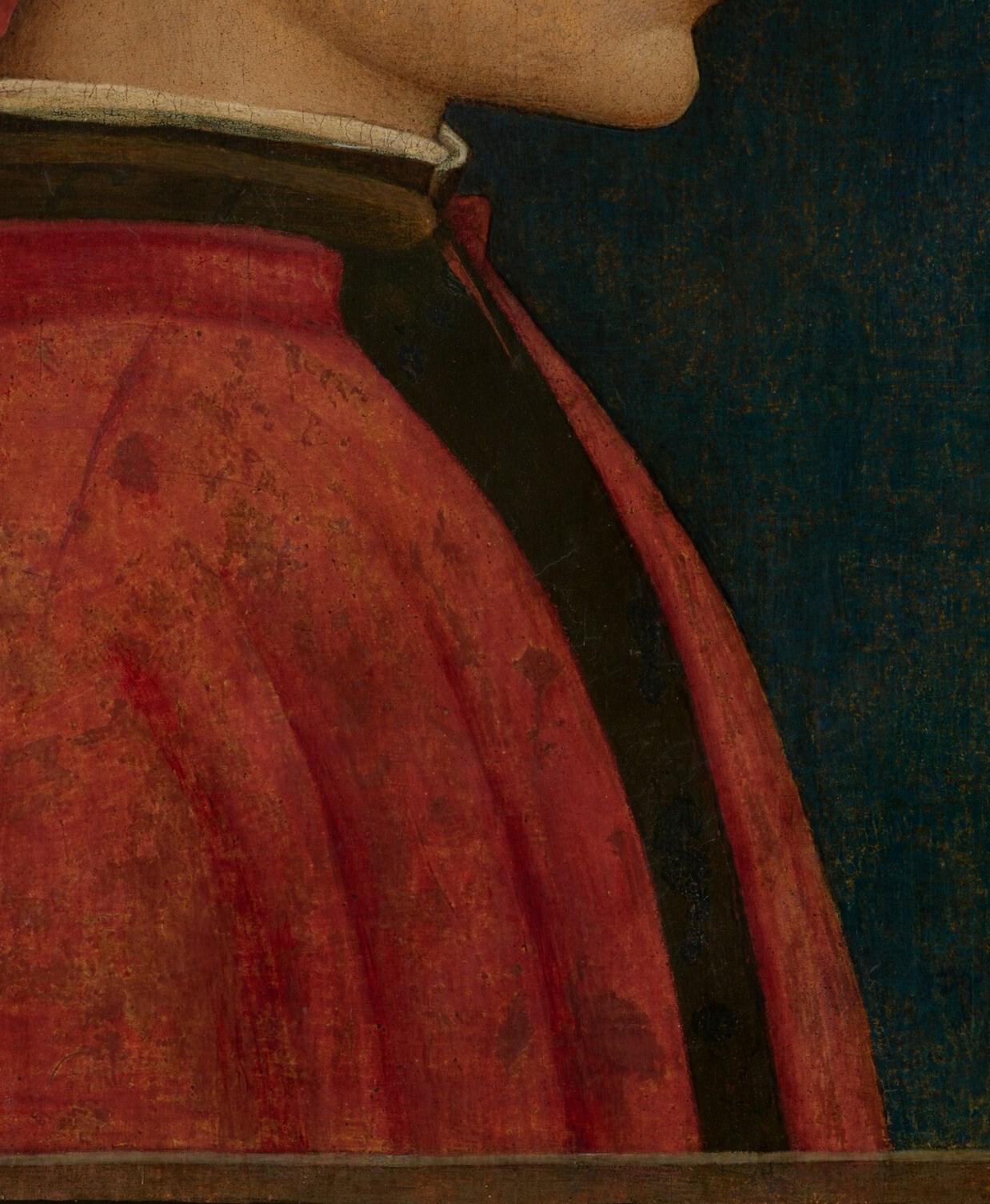 The voluminous folds and deep red hue of the robe convey a sense of opulence and importance.