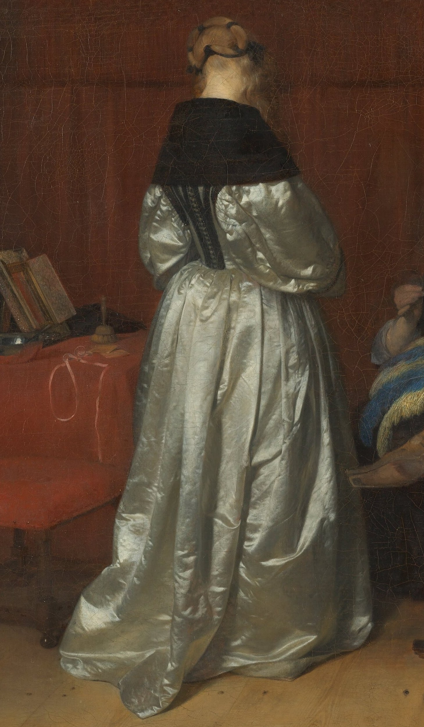Her pose and the lustrous fabric suggest a moment of attention or perhaps a subtle invitation.