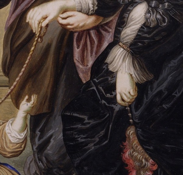 Their hands touch at the wrist, a rare show of marital affection.
