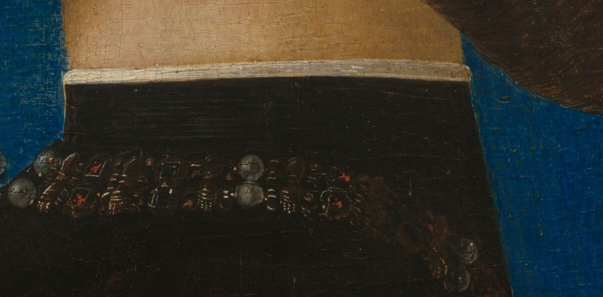 Notice his richly colored collar, edged with individual dark beads.