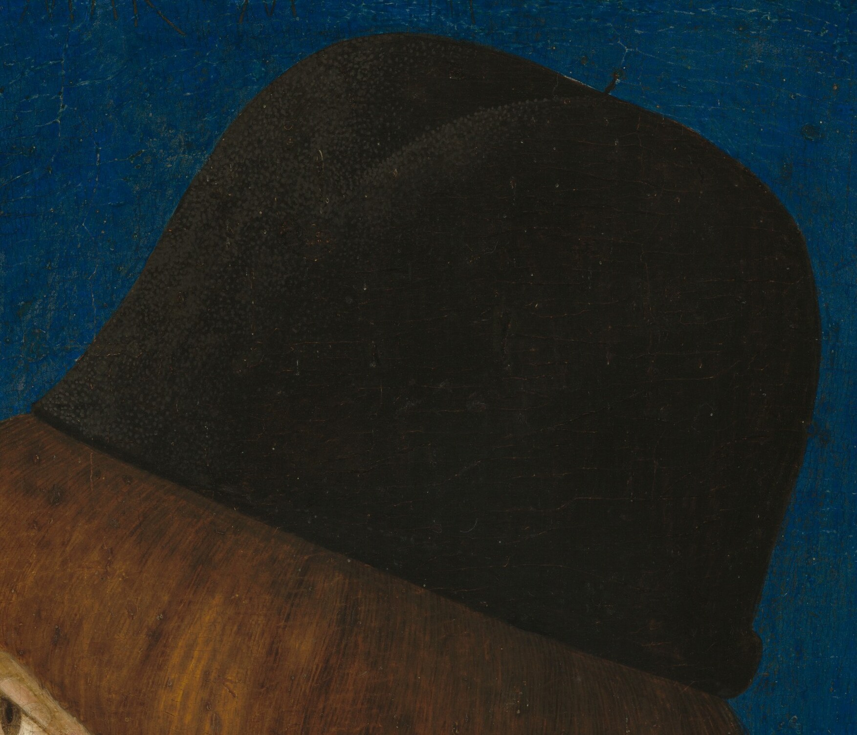 The dark hat and garment emphasize his youthful features.