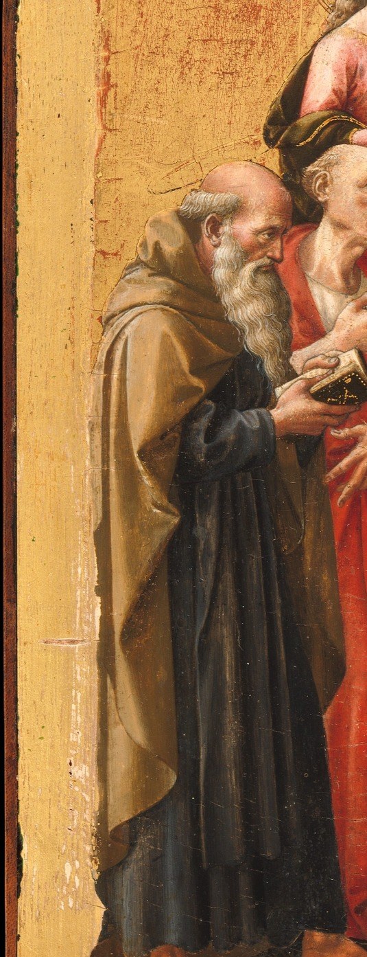 His deep-set eyes and weathered face anchor the left edge; his tau-staff attribute identifies him for the literate viewer, and his hunched posture contrasts with the upright younger saints.