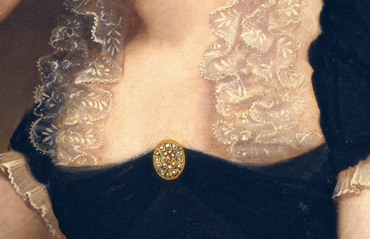 Her fine lace collar spoke of wealth and refinement.