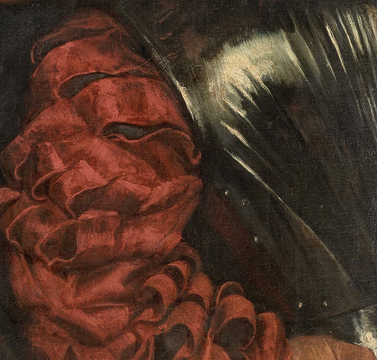 Look closely: beneath the folds of red fabric.