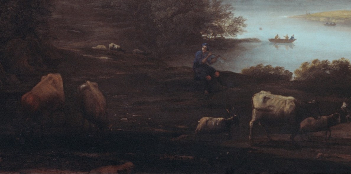 Cattle graze beside a quiet river.