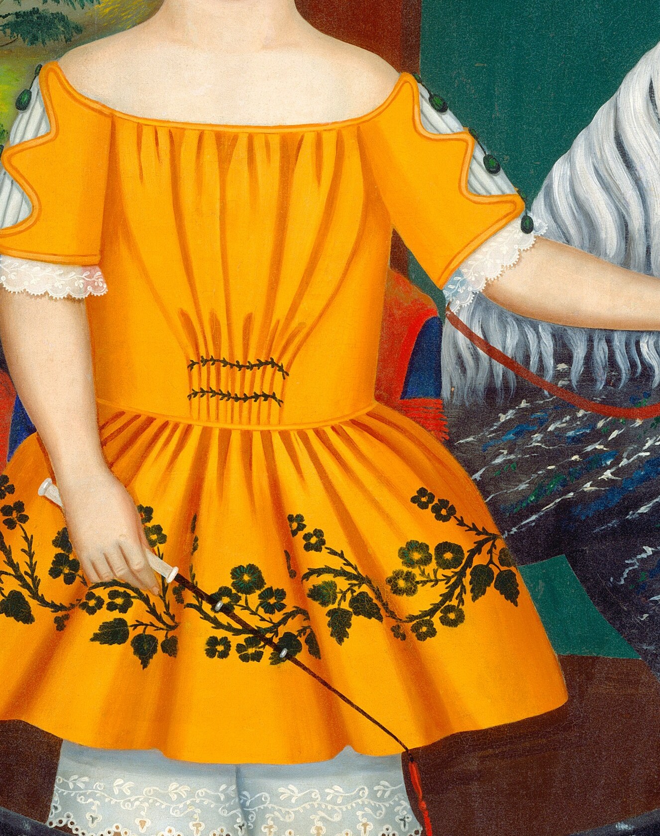 The vibrant yellow fabric, with its delicate floral embroidery, creates a striking contrast and highlights the child's presence.