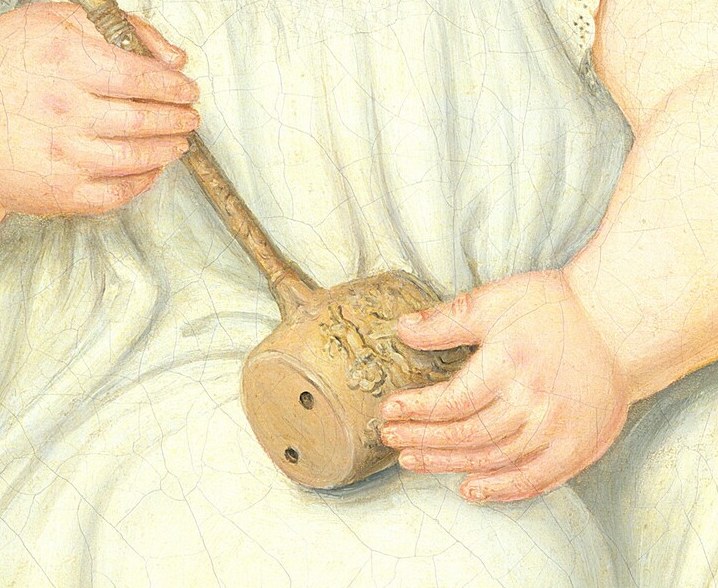 The younger boy grasps his rattle, wide-eyed and vulnerable.