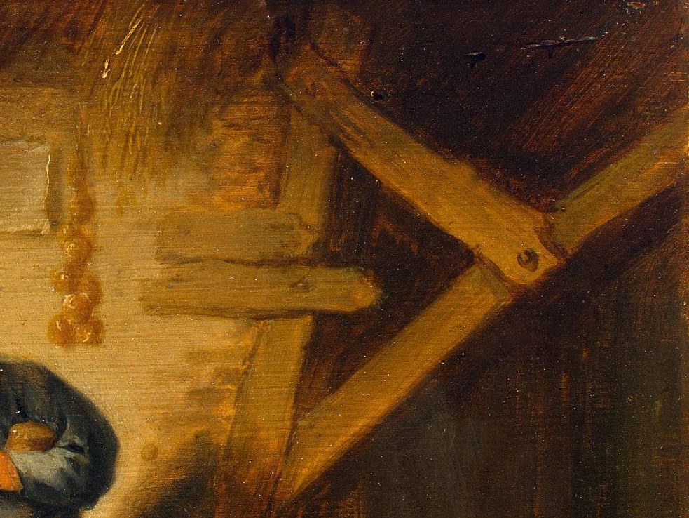 Look closely at the wooden beam above the woman.