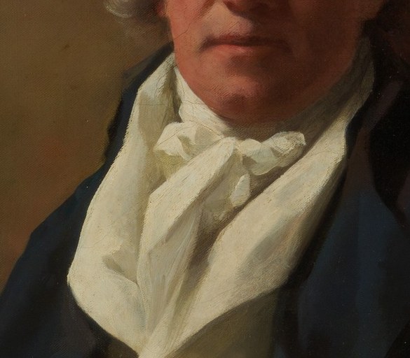 His cravat is tied with casual elegance.