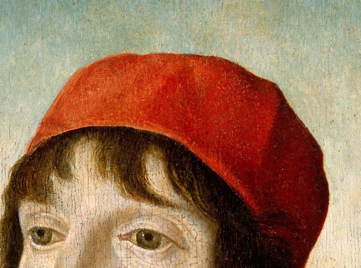 Look closely at the top, above his red cap.