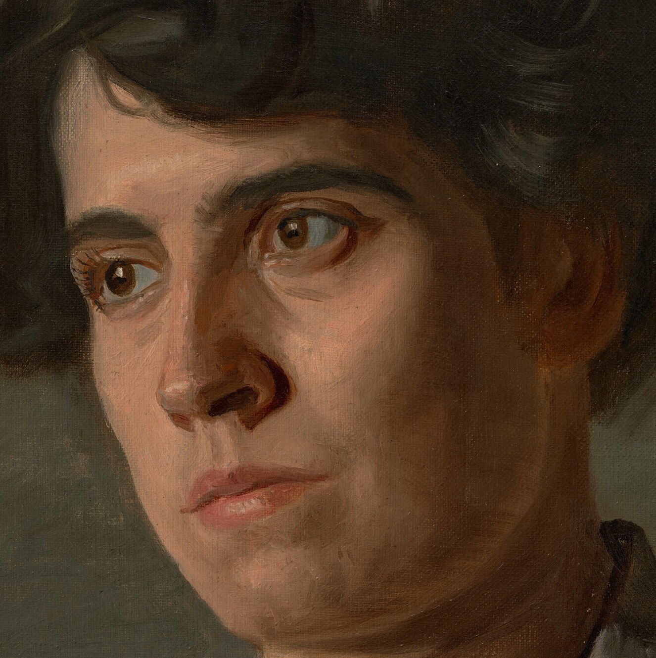 Her quiet expression suggests a reserved woman.
