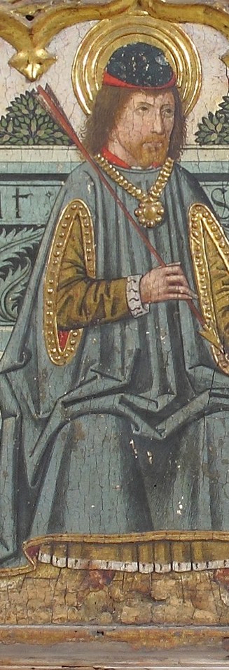 Now the center. He holds a palm, a martyr's victory branch.