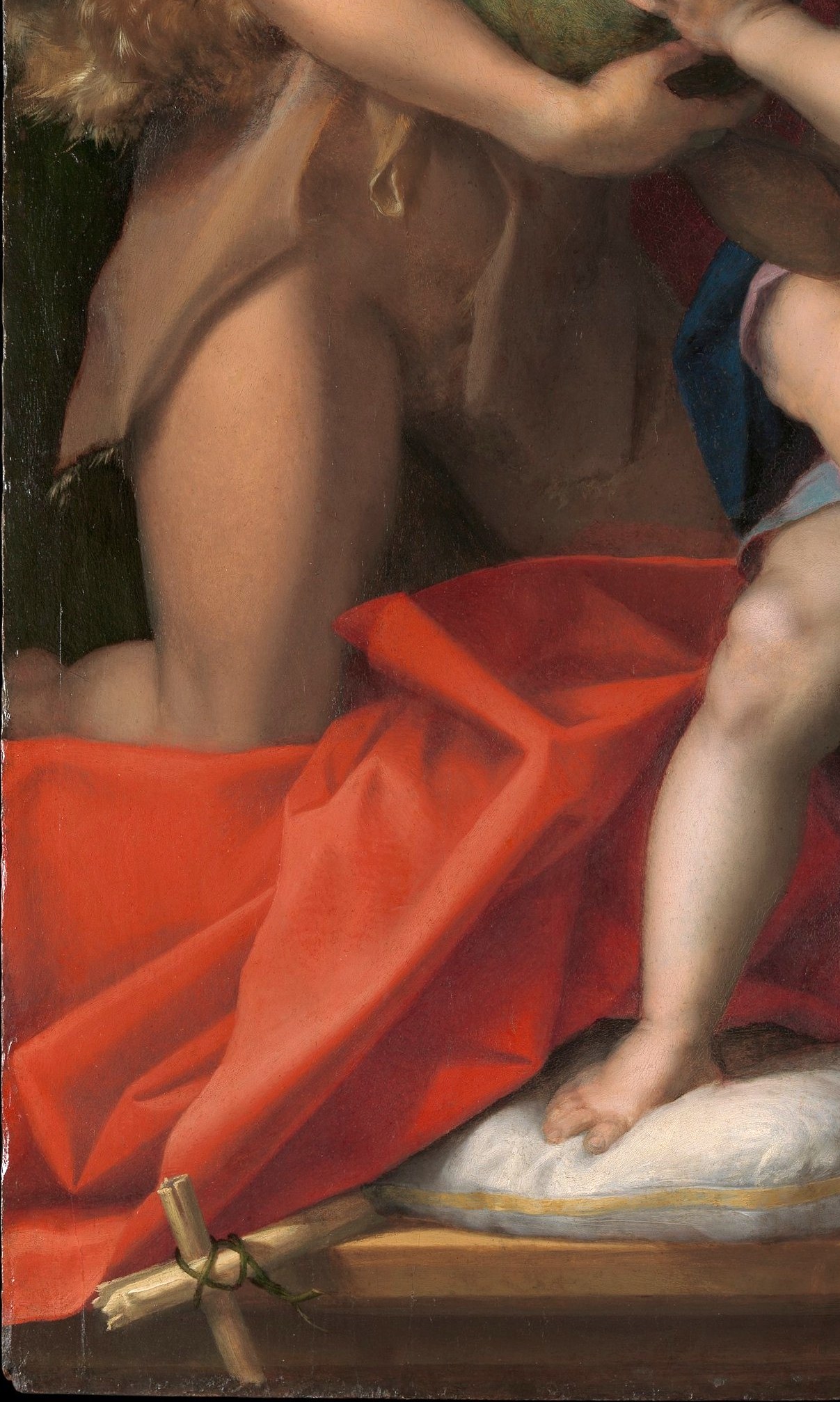 The saturated red anchors the left side and provides del Sarto's signature hot-cool contrast with the blue fabric across the base; the crumpled folds show off his control of complex light on silk.