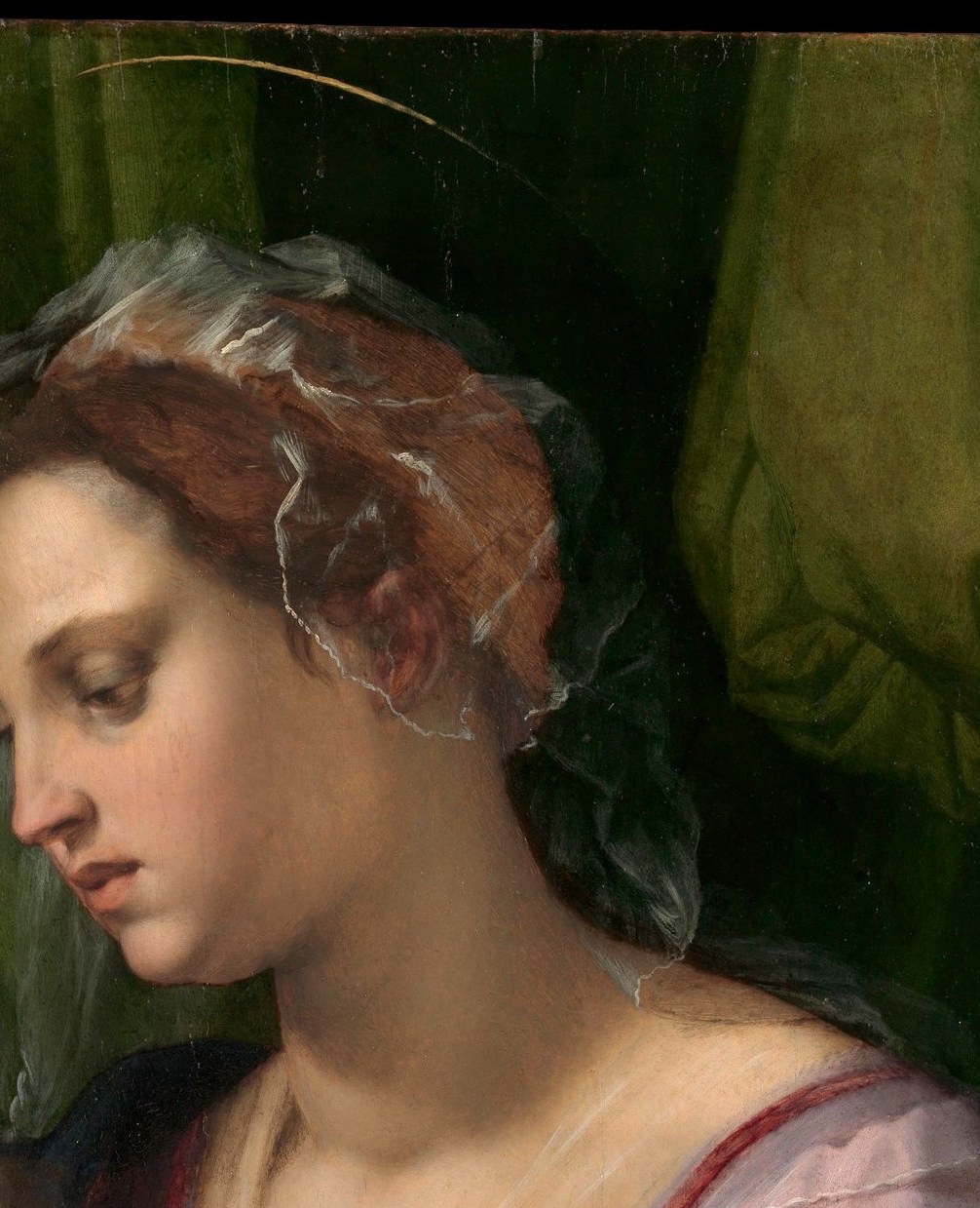 Her eyes angle downward with absorbed tenderness rather than frontal piety , del Sarto gives her an entirely human preoccupation, the hallmark of his psychological naturalism.
