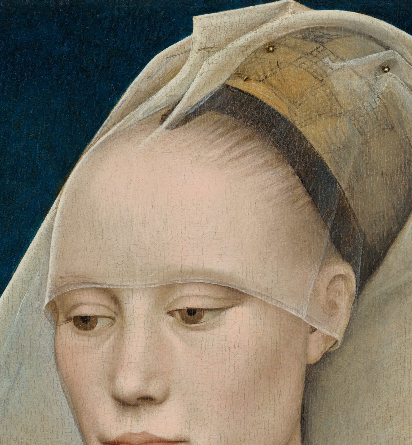 Her steady gaze and composed mouth invite close looking.