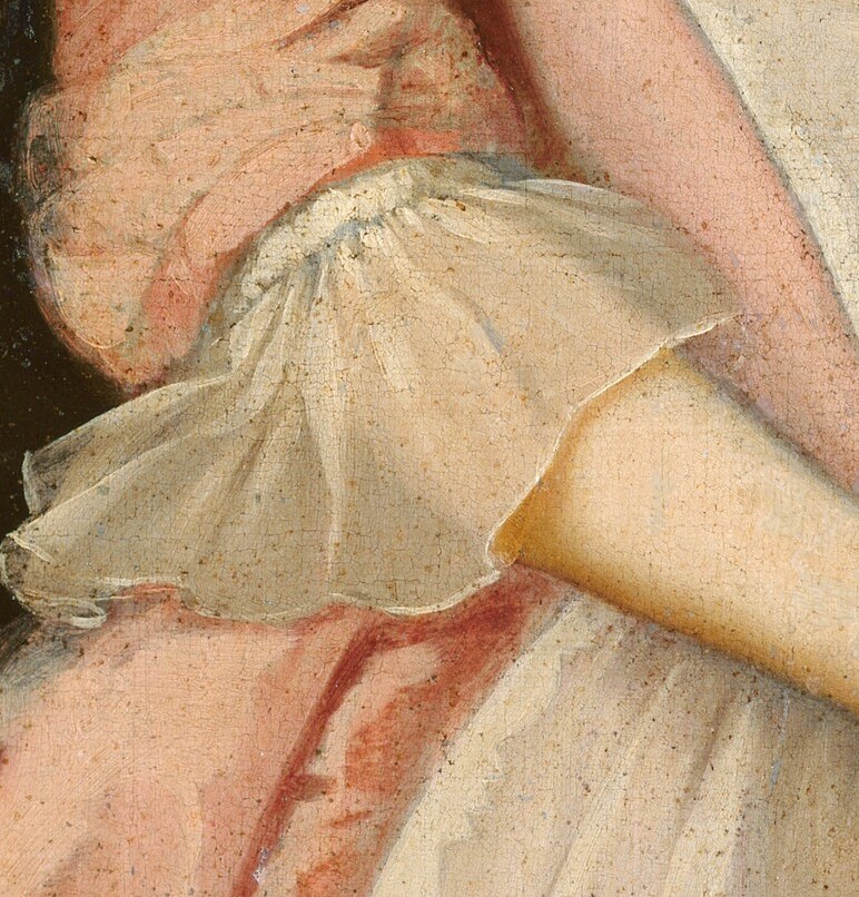 See the sheer material of her white cuffs and collar.