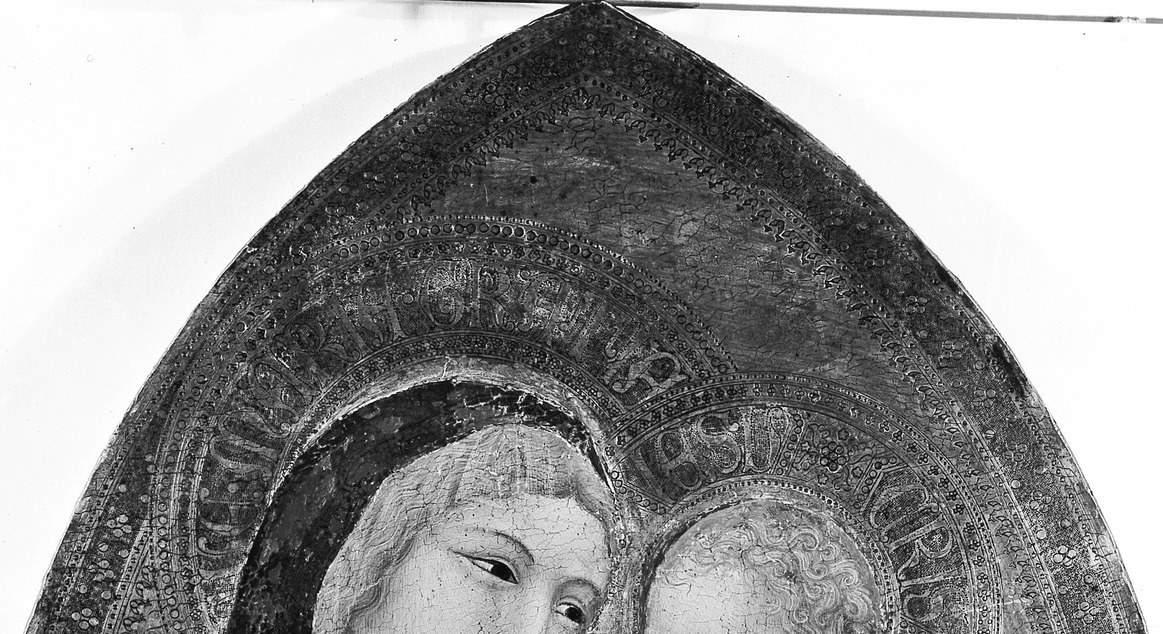 The arch format is an altarpiece convention that frames the sacred figures like a cathedral opening , its presence dates and contextualizes the work as a devotional object, not a secular portrait.