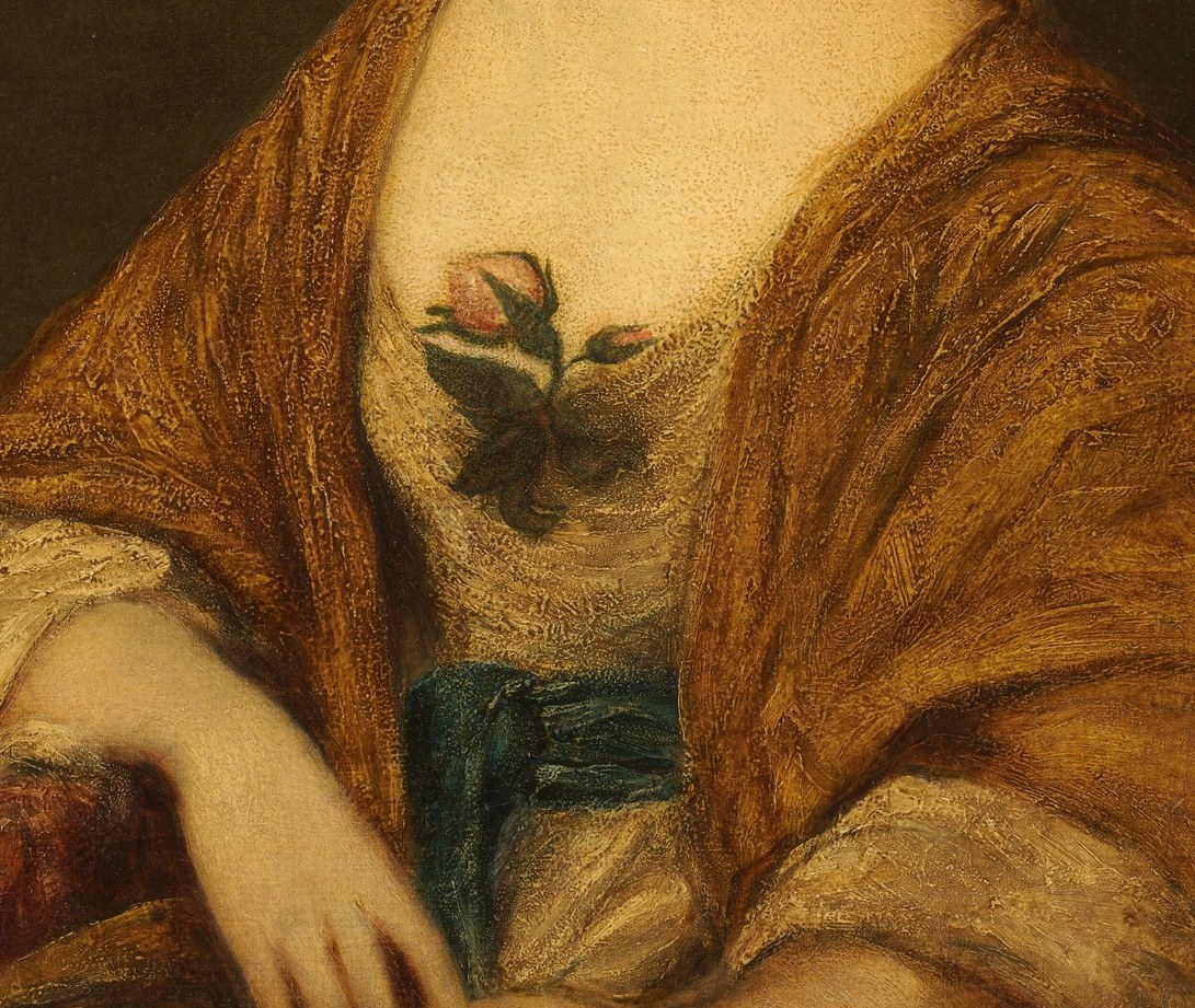 Her gold brocade dress shows her wealth.