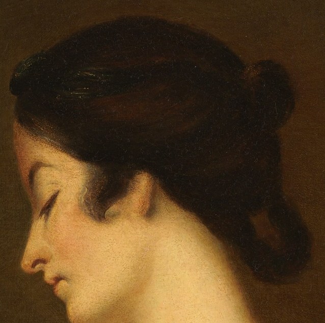 Her dark hair is styled in an elegant bun.