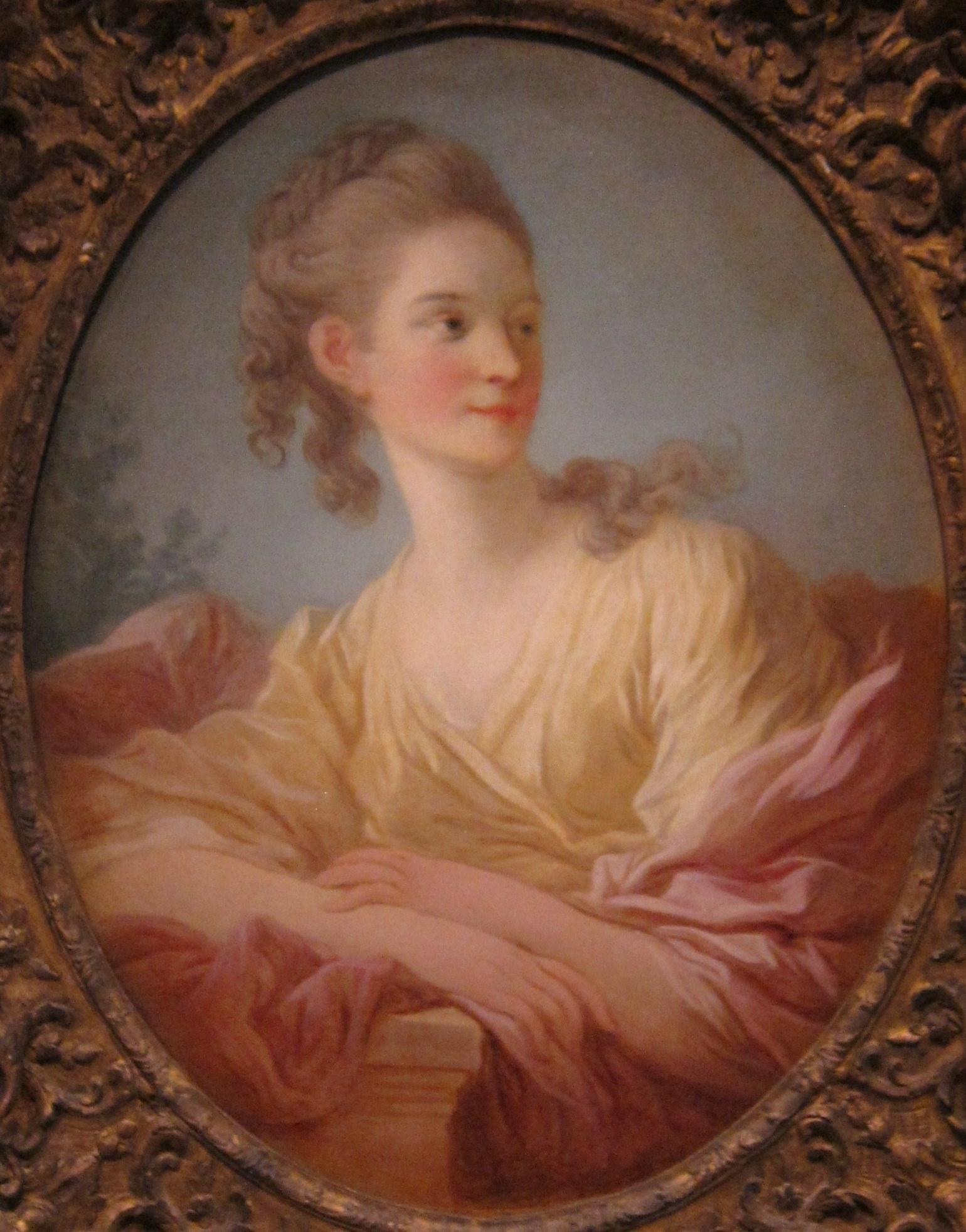 Look closely at the gilded frame, around her hair.