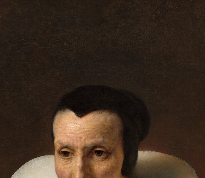 The compositional anchor , Rembrandt illuminates it from above-left, carving out aged skin, a benign expression, and unmistakable individuality from the surrounding dark.