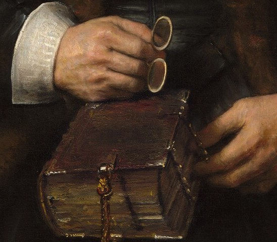 Almost certainly a prayer book or Bible , its modest size and the way the hands cup rather than display it points to private devotion rather than scholarly show.