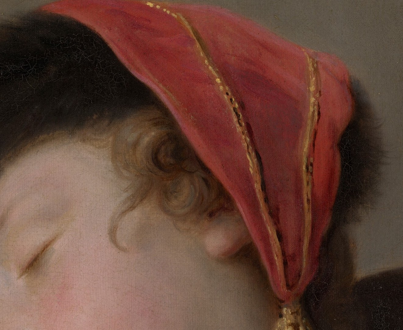 Look closely at her red silk headscarf.