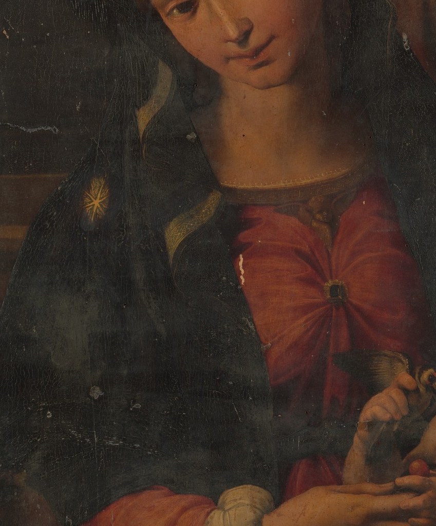 The most saturated color in the painting; red signals Mary's humanity and maternal warmth, blazing dramatically against the near-total surrounding darkness , a deliberate Mannerist chromatic shock