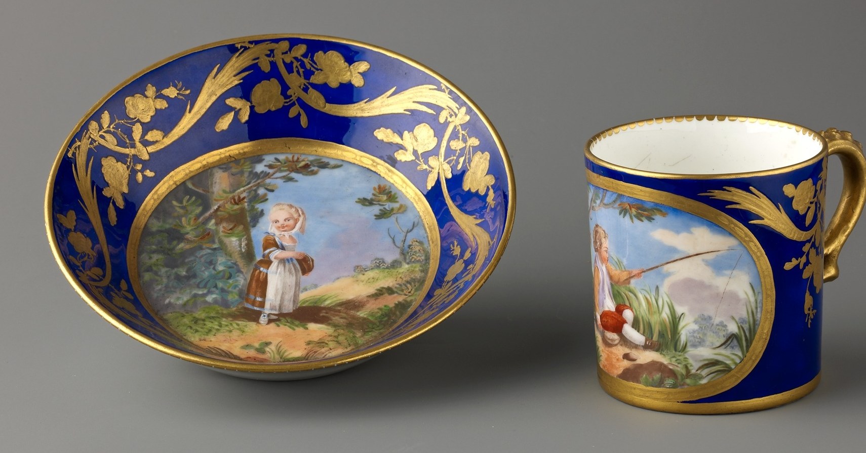 The rich, uniform blue provides a striking backdrop for the painted scenes and gold accents.