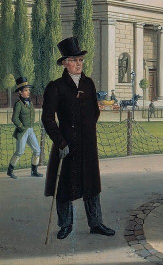 He stands with a cane, appearing contemplative or perhaps waiting, adding a narrative element to the scene.