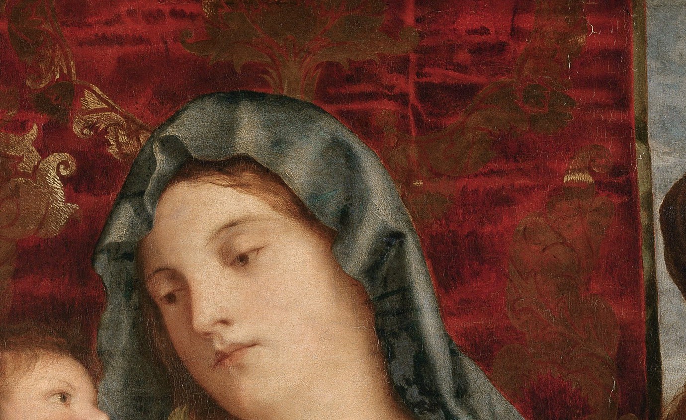 A rich tapestry suggests a sacred yet domestic setting.