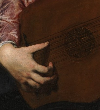His hands are poised, capturing a delicate moment of music.