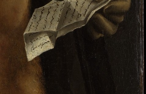 In his hand, he holds a carefully folded letter.