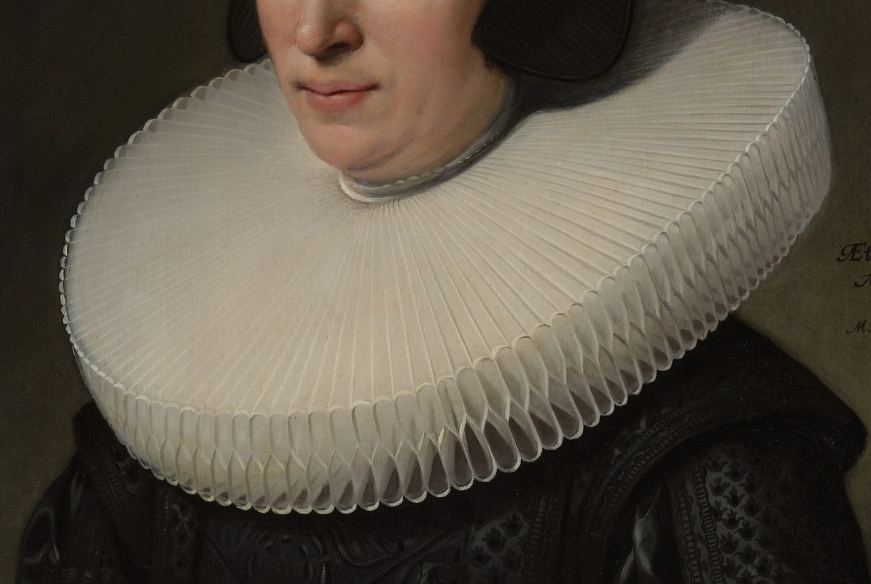 She gazes with quiet dignity from behind a pristine ruff.