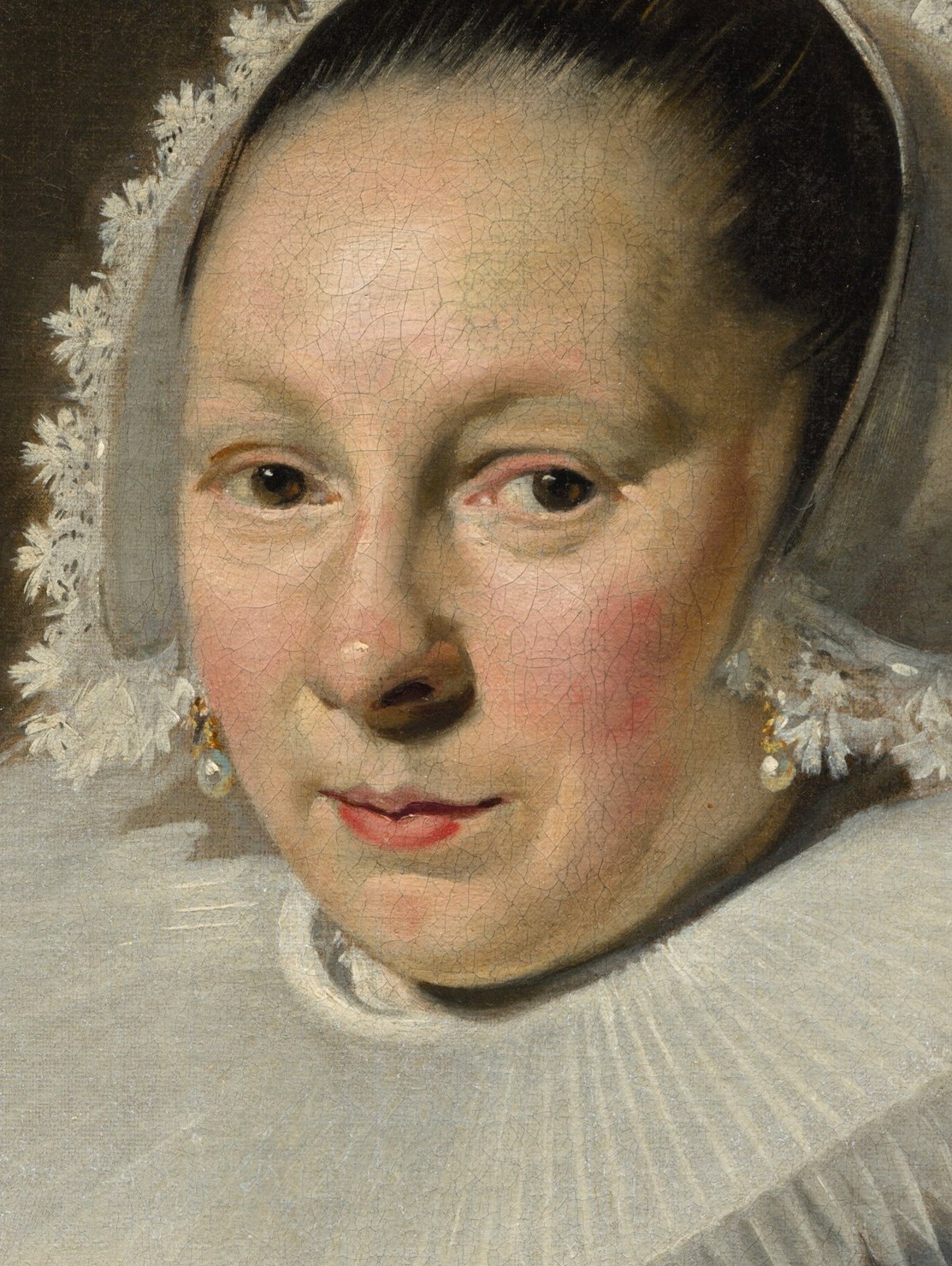 Her direct gaze and slightly parted lips suggest a moment of contemplation or subtle engagement with the viewer.